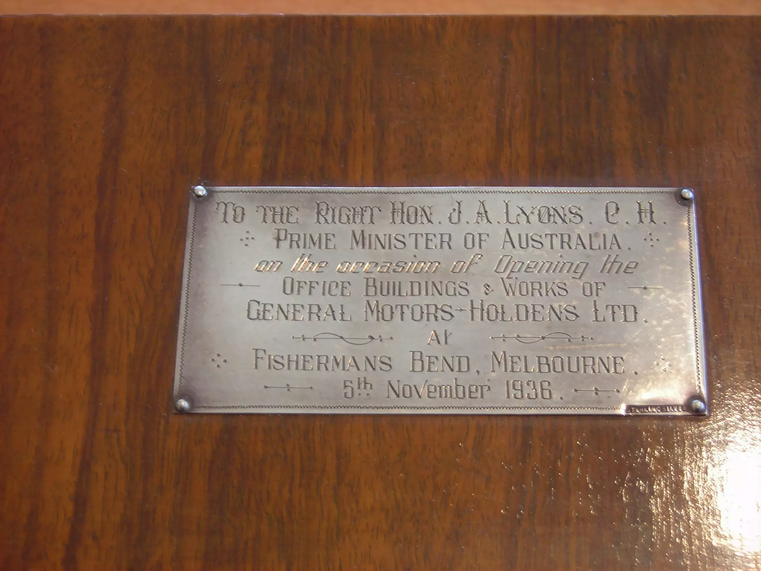 An engraved plaque on a brown clock 