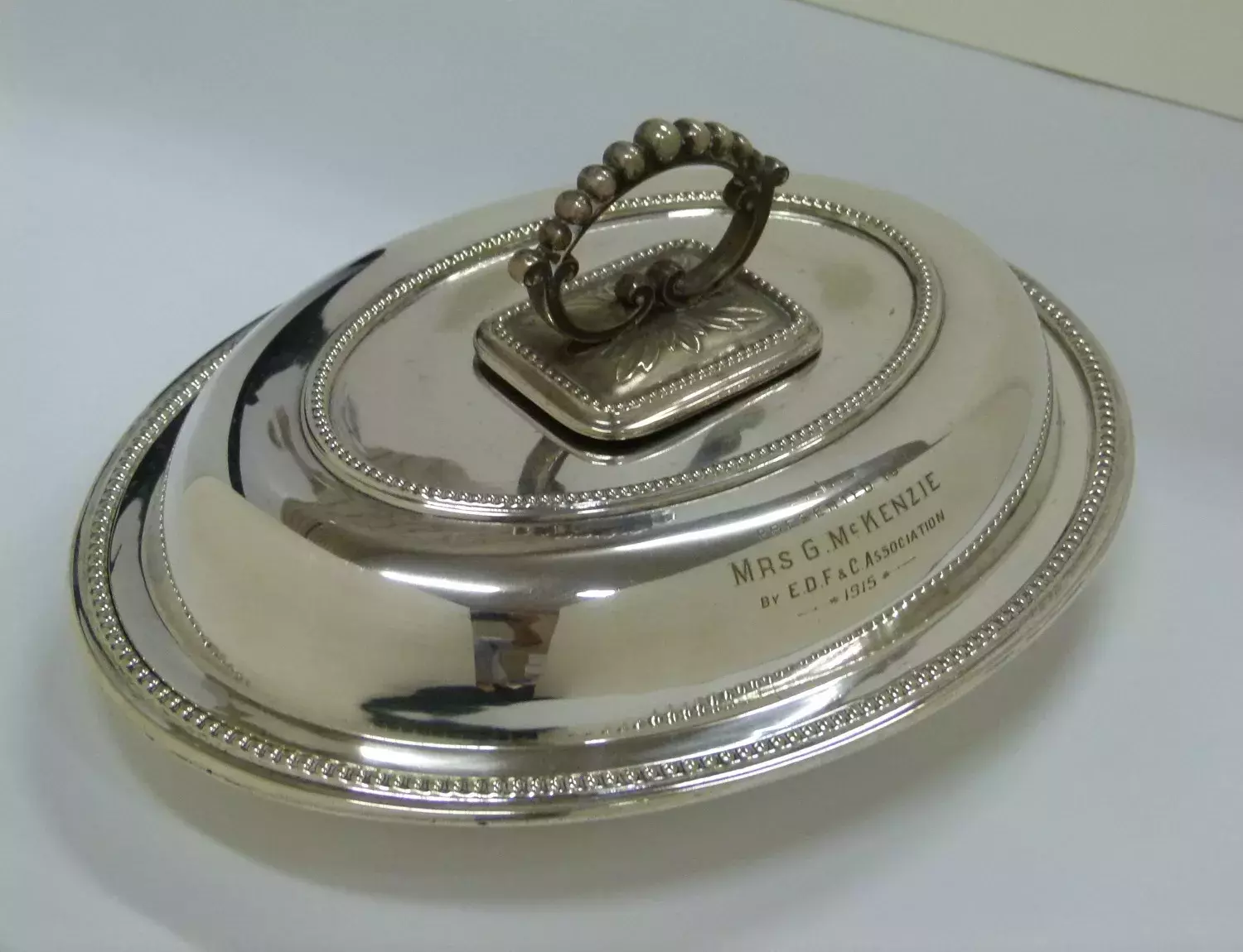 Silver entree dish lid with engraving.